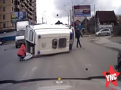 An ambulance overtakes a red signal overturned in a traffic accident at a crossroads - Russia