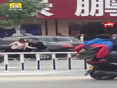 love couple fight in the street she falls to the ground and then he leaves her there in Guangdong