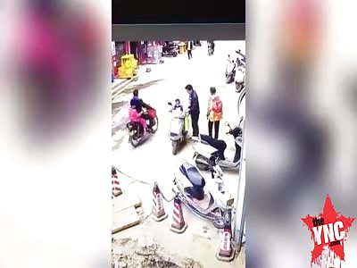 a family fall into a pit on there motorcycle in  Guangdong