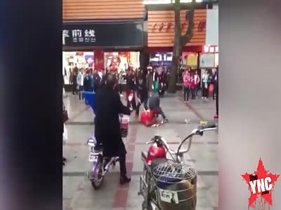 man hit with bamboo stick by police man in Guangdong
