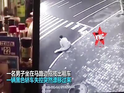 A man sat on the side of the road by the zebra crossing gets crushed  in Qiqihar, Heilongjiang
