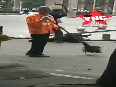 man beats up his daughter-in-law on the street with  wooden stick in  Guangxi