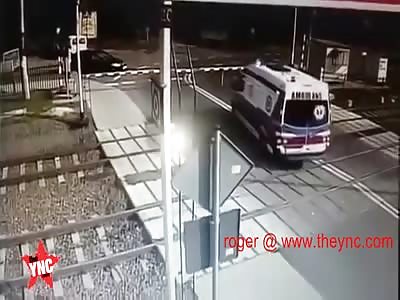 Polish Ambulance Driver Gets Vehicle Stuck on Railway Crossing, Train Plows Them 