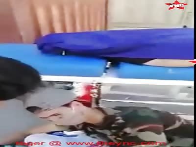 boy will not leave his dead father side after the hospital put him out side in iraq.