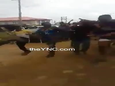 Bruised thug caught by a mob and hit with sticks