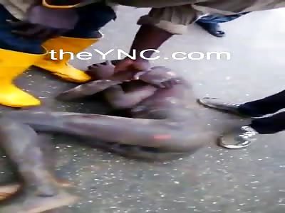 Naked thug is dragged around by mob