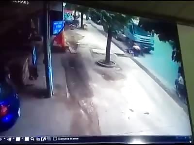 Two People on a Motorbike Squashed by a Truck