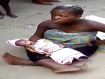 Woman with Crippled Legs Cradles Her Murdered Newborn Baby