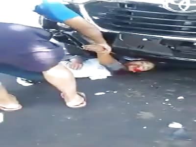 Agonizing Woman Pulled From Under a Car