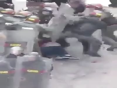 Woman beaten by dozens of police