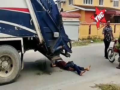 Man dies after being hit by garbage truck. 
