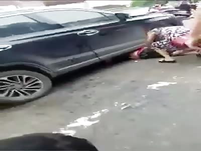 Asian woman is rescued after being crushed by a vehicle