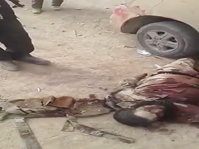 the Syrian rebels present the bodies of their victims attacked with high-caliber weapons