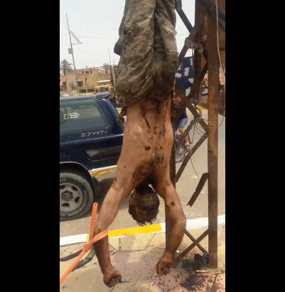Terrorist Daesh Throat Slit hanging upside down exhibited in the streets of Syria