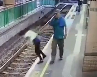 Sick Man pushes woman to the train lines