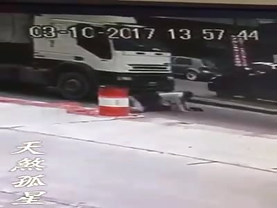 Old woman slips and is crushed by a truck