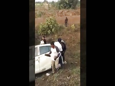 People looting from car after accident 