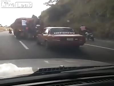 Venezuelans Apparently Jacking Cargo Off Moving Truck as Moto-Cop Watc