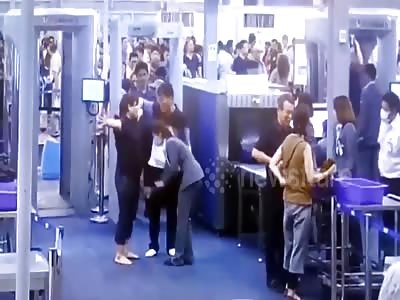 Angry tourist karate chops a female worker...