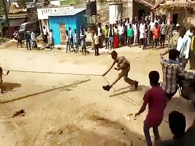 Indian Policeman Warns Crowds About Bull...