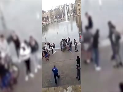 Teens kick another boy in the head as security guard stands by