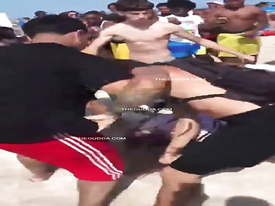 Dude Gets Pummeled On The Beach!