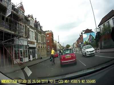 Cyclist flips over handlebars in traffic