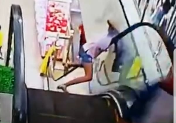 Woman Damn Near Loses Her Head on Escalator