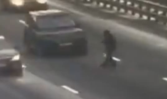 Guy Crosses Highway at the Perfect Time