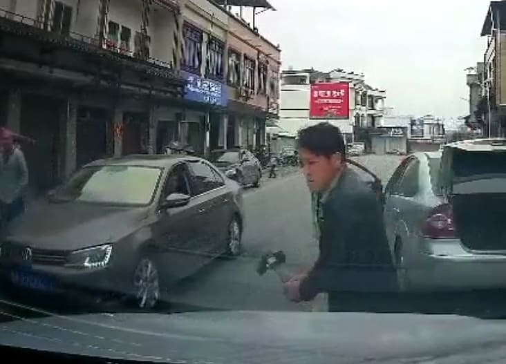 Lunatic Smashes Car with a Hammer
