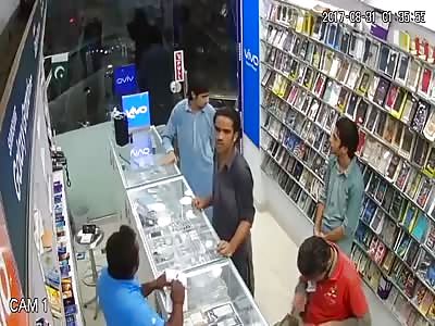 Robbery caught on CCTV stealing from cell phone shop
