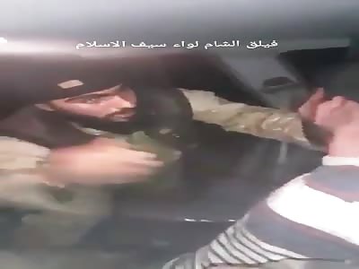 Faylaq al-Sham militant torturing a regime fighter