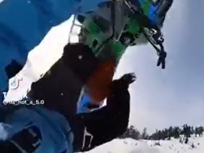 Snowmobile Lands on Top of Man after Failed Ramp Jump