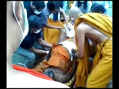 Bizarre Video of an Important Monk being Prepared for Show in his Glass Coffin 