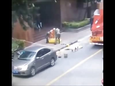 Watch the Moment a Female Suicide Jumper Hits the Sidewalk Almost Crushing these Workers
