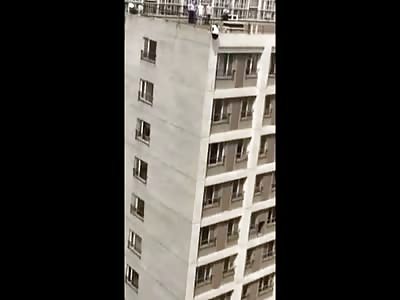 Woman in Yellow Jumps From Top of Building to End it All