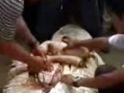 Natives Chainsaw a Crocodile after Removing Body Parts of Little Boy from its Stomach