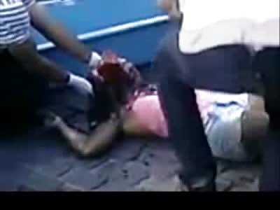 Woman in Pink Head Crushed is lifted and Placed in Coffin off the Street