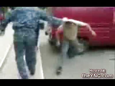 Militia Member kicks a Man's Head in while a little kid watches