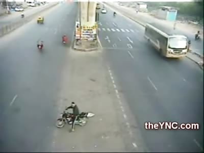 Biker waiting to make a Turn Loses his Bike and is Lucky to be Alive