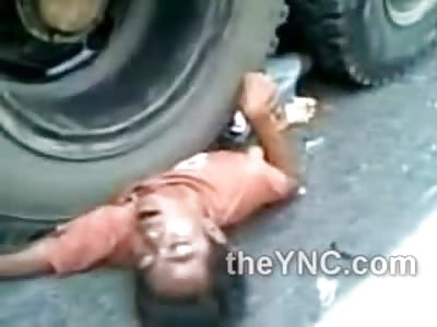 Man Crushed Under Full Weight of Truck Wheel ....Crowd in Awe