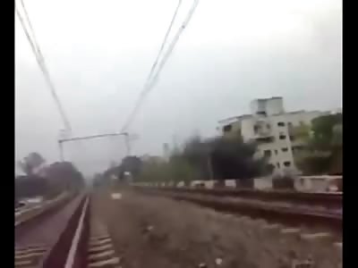 Complete Lunatic Poses and Mocks oncoming Train, then lies under It