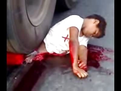 Short Video of Young Boy Crushed underneath Truck and Still Alive