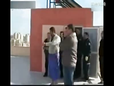 Couple attempts Feeble Suicide off Rooftop
