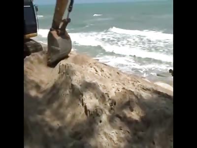 Construction Equipment used to remove Dead Woman from Beach Sand...and shes in 2 Pieces