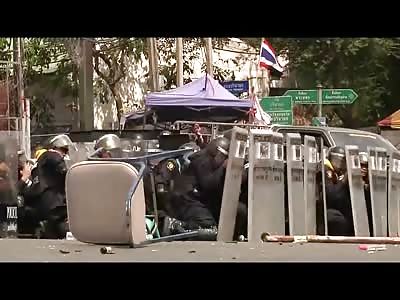 Thai Police Officer gets his Leg Blown off by kicking away a Grenade thrown by Protester...(Watch Slow Motion)