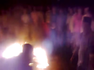 Crowd creates a Campfire with a Human Being and his Motorcycle