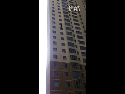 Chinese Man Dangling from High Rise decided to Let Go