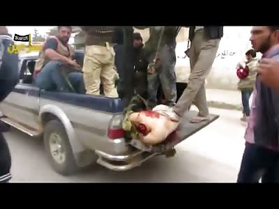 Terrorists Drive Away in a Pickup Truck with a Headless Corpse in the Back