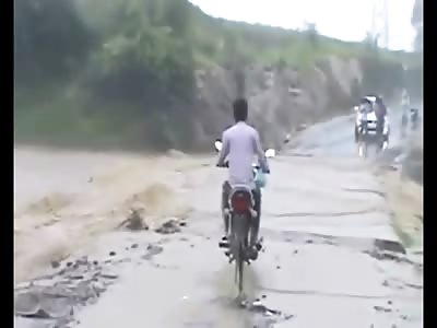 Incredible Video Shows a Not So Bright Guy Try Riding his Motorcycle Through Flood Waters only to Drown